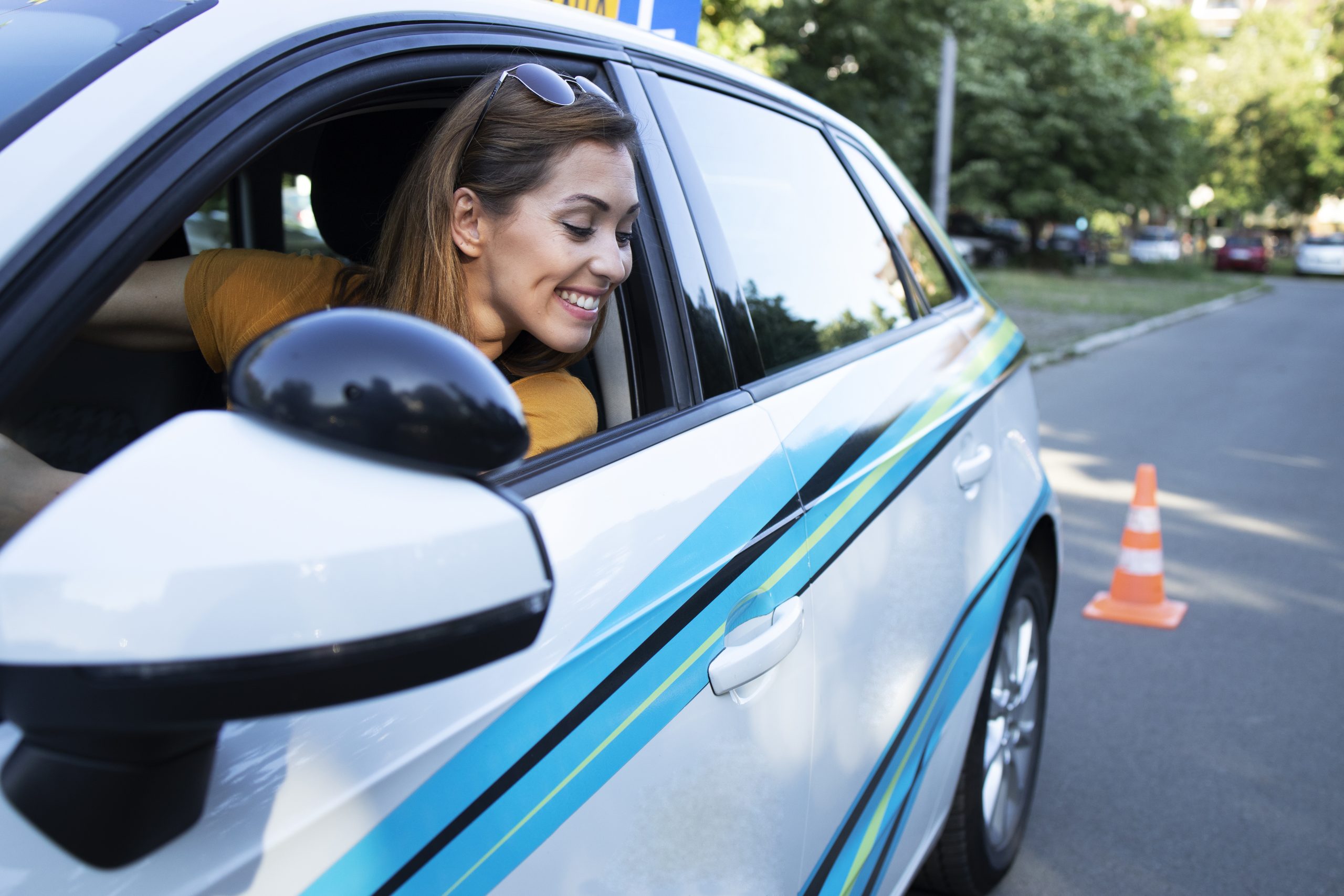 Woman learning to drive a car and going reverse.